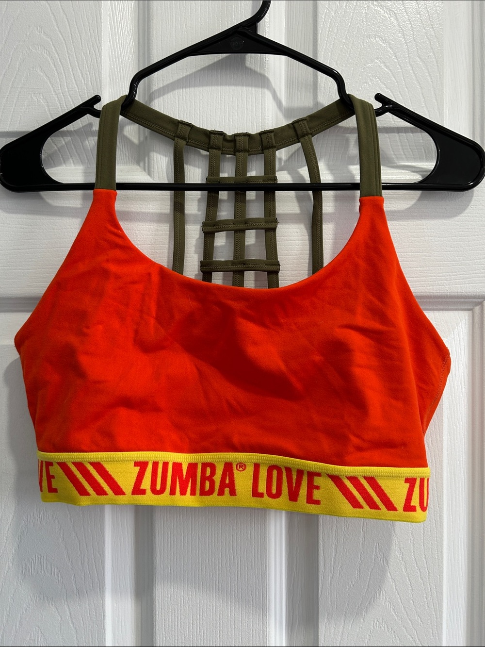 Zumba Fitness orange sports bra with olive straps and yellow logo band